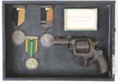 Kinvara 1916 and War of Independence Medals awarded to brother and sister, Joe and Annie Kilkelly, Kinvara, Co. Galway and revolver owned by Joe Kilkelly.   Image:  Adams.ie